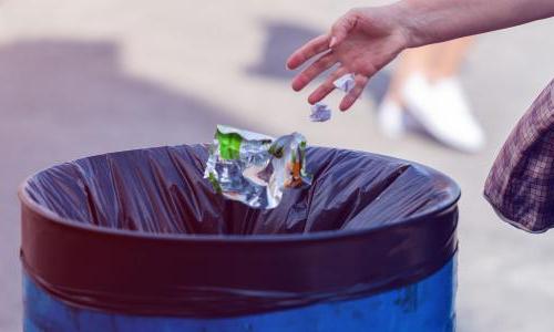 throwing a piece of trash in the garbage